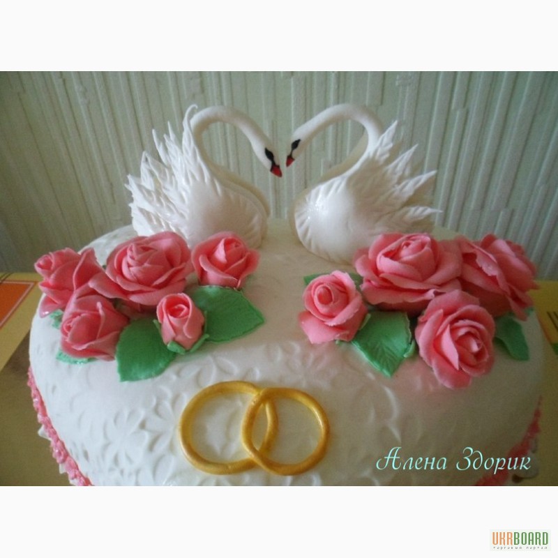 Фото 2. Свадебный торт в виде сердца с лебедями и кольцами